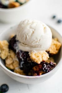 bowl of blueberry cobbler with ice cream
